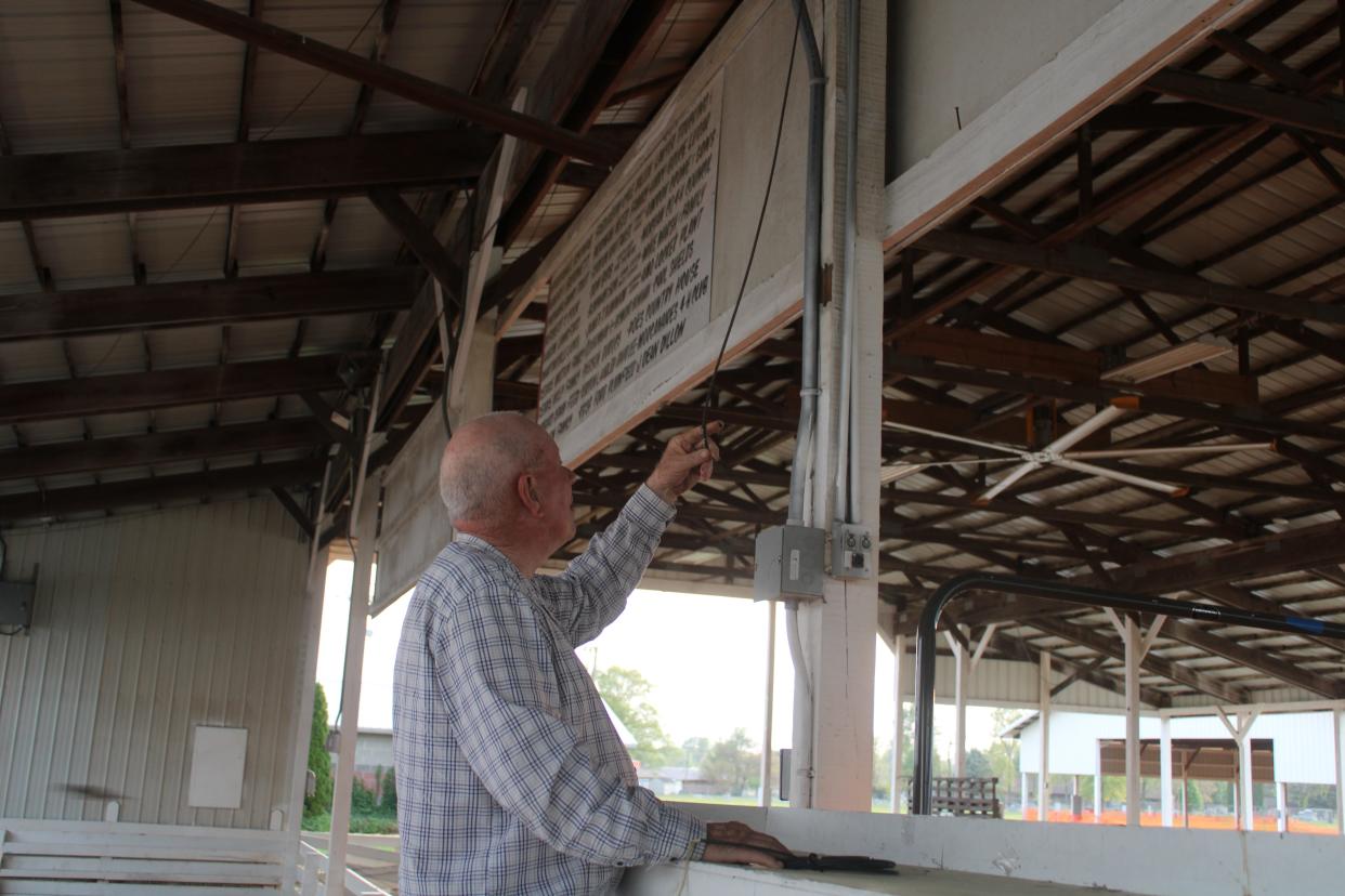 Morgan County Fair board member Bill Rumbaugh checks on damage done to the wiring in the show arena. The estimated cost to replace the wiring is around $13,000.