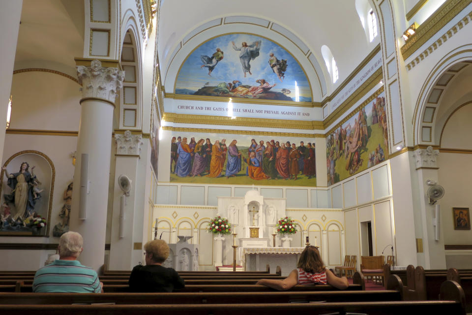 FILE - Visitors sit in St. Peter's Church in this Aug. 17, 2014, file photo, in Portland, Maine. A change in statute of limitations laws has allowed several women who claim to be victims of sexual abuse at St. Peter's from 1958 to 1967 to sue the Roman Catholic Diocese of Portland. (AP Photo/David Sharp, File)