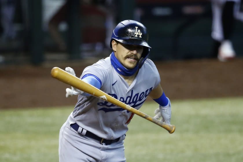 Los Angeles Dodgers' Kiké Hernandez tosses his bat away as he hits a short pop fly against the Arizona Diamondbacks.