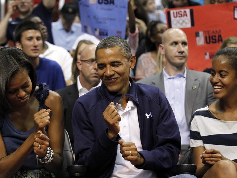 Obamas watch a basketball game