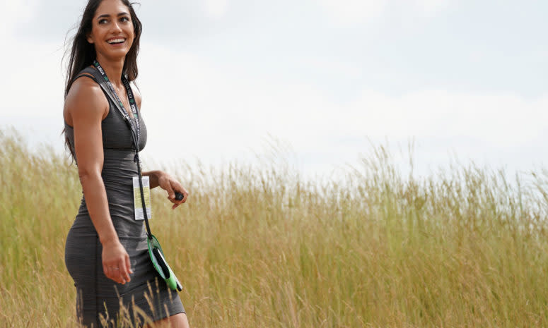 Allison Stokke walks through a golf course.