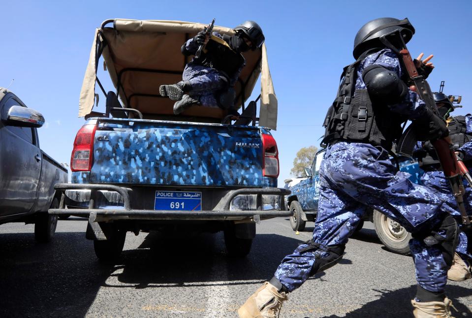 Armed Houthi soldiers jump off a pick-up vehicle while on patrol in a street in Sana’a, Yemen (EPA)