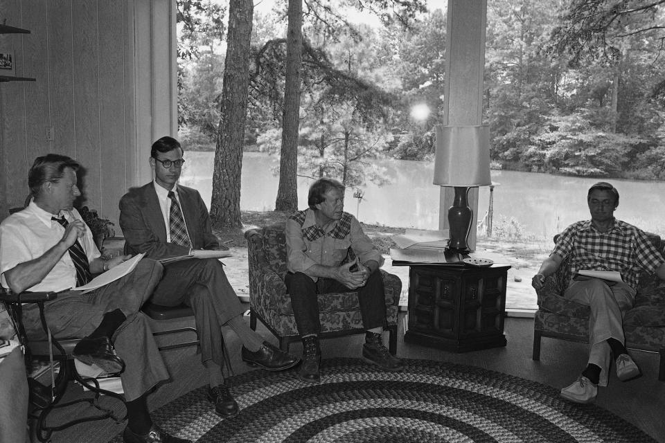 <p>Democratic nominee Jimmy Carter, center, talks with Zbigniew Brzezinski of Columbia University and Carters foreign policy advisor, left, and Stuart Eizenstat, director of issues and policies, second from left, Thursday, July 29, 1976, Plains, Ga. Carter is being briefed on foreign policy in the Carter pond house which is used as country home. The man on the right is unidentified. (Photo: Peter Bregg/AP) </p>