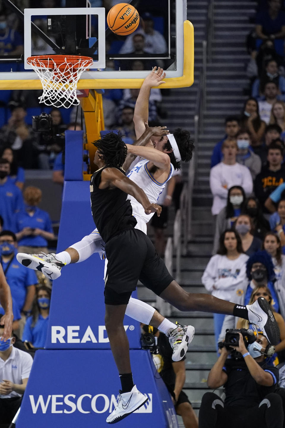 UCLA guard Jaime Jaquez Jr., right, is fouled by Colorado forward Jabari Walker during the first half of an NCAA college basketball game in Los Angeles, Wednesday, Dec. 1, 2021. (AP Photo/Ashley Landis)