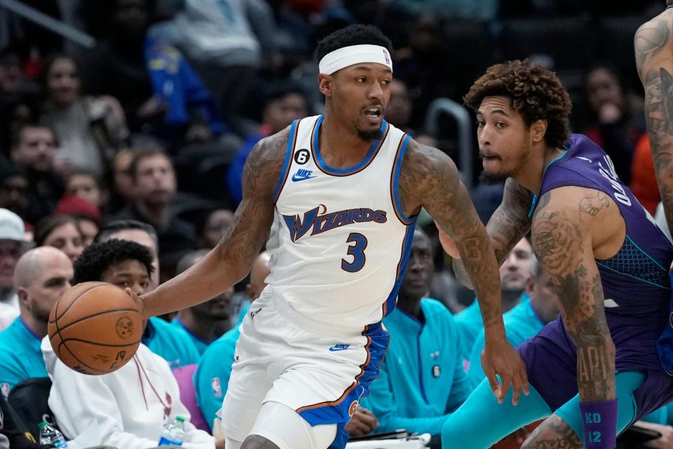 Washington Wizards guard Bradley Beal (3) moves past Charlotte Hornets guard Kelly Oubre Jr., right, during the first half of an NBA basketball game in Washington, Sunday, Nov. 20, 2022. (AP Photo/Susan Walsh)