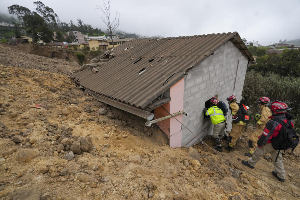 Rescue workers inspect a house destroyed by a deadly landslide that buried dozens of homes in Alausi, Ecuador, Monday, March 27, 2023. (AP Photo/Dolores Ochoa)