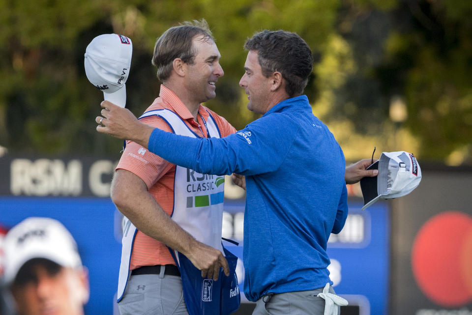 Charles Howell III, right, celebrates with his caddie Nick Jones, left, after winning a playoff in the final round of the RSM Classic golf tournament on Sunday, Nov. 18, 2018, in St. Simons Island, Ga. (AP Photo/Stephen B. Morton)