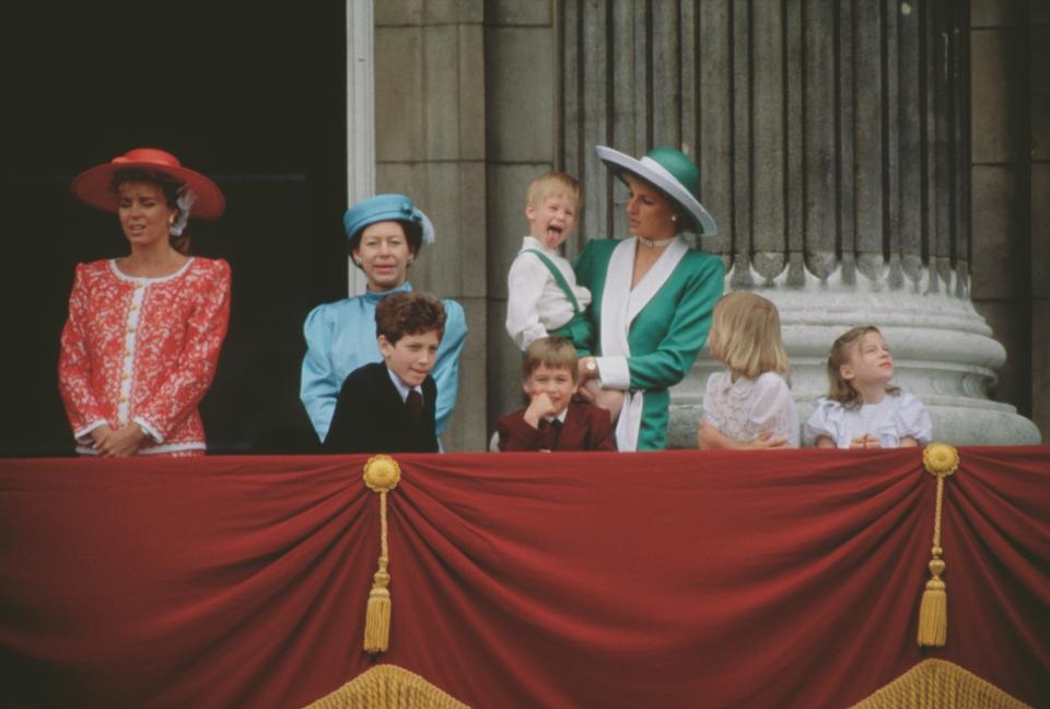 The royal family on the balcony of Buckingham Palace in London during the Trooping the Colour ceremony, June 1988. From left to right, Queen Noor of Jordan, Princess Margaret, Lord Frederick Windsor, Prince William, Prince Harry and Diana, Princess of Wales. Diana is wearing a green and white dress by Catherine Walker. (Photo by Jayne Fincher/Princess Diana Archive/Getty Images)