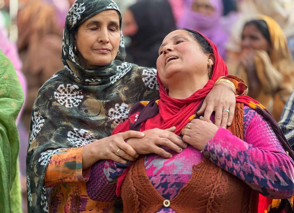 A woman mourns the killing of her brother-in-law Puran Krishan Bhat, who is from the minority community of Kashmiri Hindus, outside his home in in southern Shopian district, Indian controlled Kashmir, Saturday, Oct. 15, 2022. Assailants on Saturday fatally shot Bhat in violence police blamed on militants fighting against Indian rule in the disputed region. (AP Photo/Faizan Mir)
