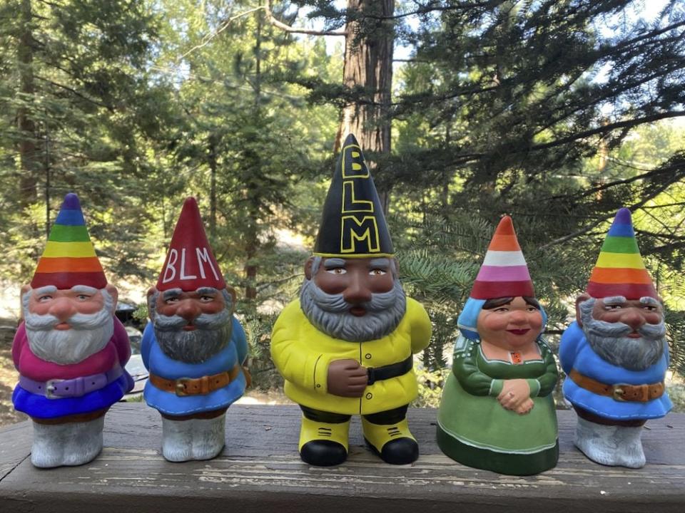 This Sept. 21, 2020, photo provided by Ashleigh Boutelle in Twin Peaks, Calif., shows Black Lives Matter gnomes and gay pride gnomes he painted and is selling online. (Ashleigh Boutelle via AP)