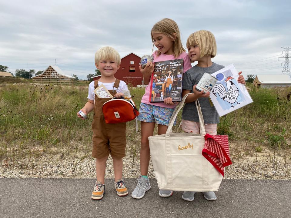 Children pose in front of Critter Barn's new facility at the corner of 80th Avenue and Felch Street in Zeeland Township.