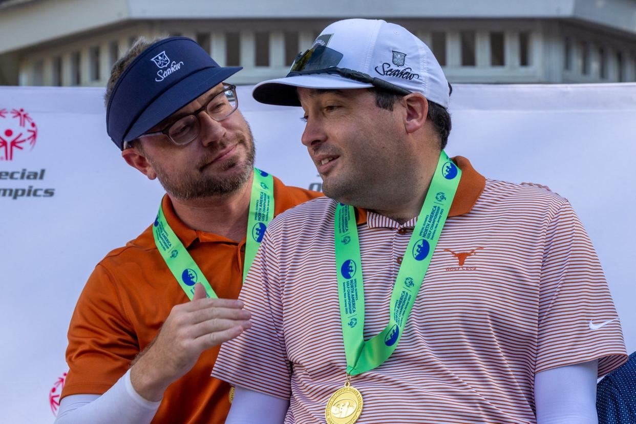 Drew Widney, left, and Matthew Wright show off their medals after winning the unified division at the Special Olympics North America Golf Championship in New Jersey.