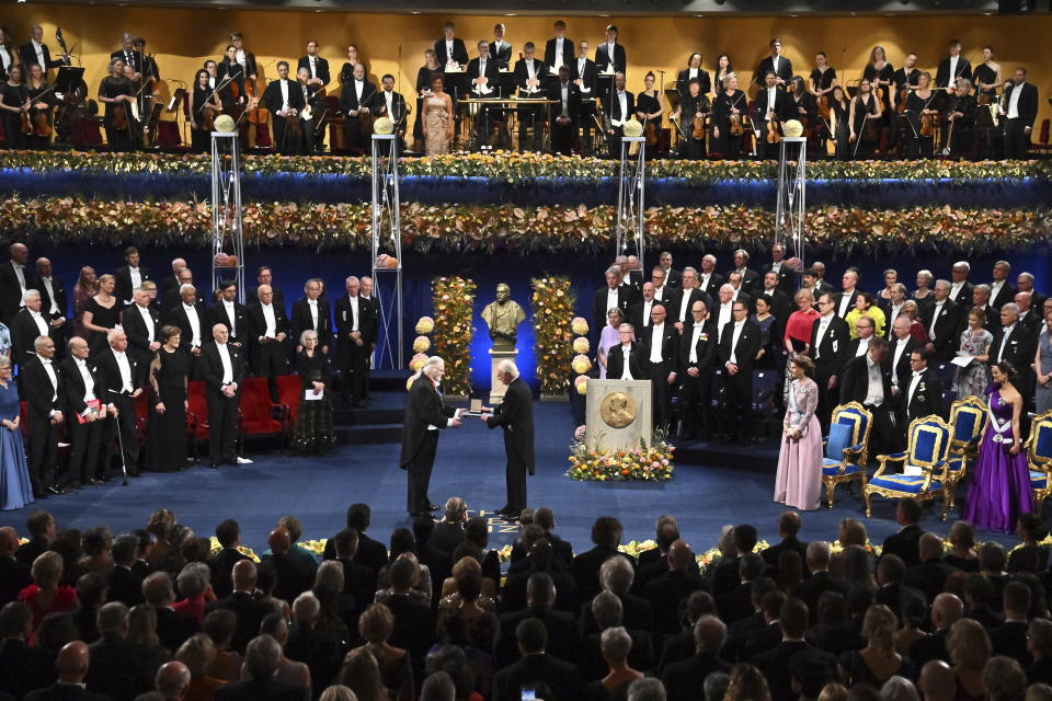 Jon Fosse, left, is awarded the Nobel Prize in Literature 2023 by King Carl Gustaf of Sweden during the Nobel Prize award ceremony at the Concert Hall in Stockholm, Sweden, Sunday Dec. 10, 2023. (Claudio Bresciani/TT via AP)