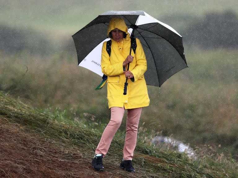 Britain is set to be hit by heavy rain and thunderstorms over the coming days before scorching temperatures return, the Met Office has warned.The weather service issued a “yellow” emergency alert for rain in the south of Wales, as torrential downpours disrupted bus and train services on Friday morning. Most of Britain will see some showers throughout the day, with thunder expected to sweep around Manchester and the west coast of Wales.Golf fans at The Open in the far north of Northern Ireland can expect cloudy skies with a few outbreaks of rain in the afternoon on the second day of the competition. But over the the weekend, spectators are likely to see prolonged downpours lasting up to an hour. However, Saturday will see a brighter start for some with a few showers, while heavy and possibly thundery downpours persist in the north-west of England. Northern Ireland and the west of Scotland will see the wettest weather with persistent rain expected over the first 36 hours of the weekend. It comes at the end of a hot and muggy week, with temperatures hitting 27C in London on Tuesday.On Sunday there is a clear North-South split, with dry and warm conditions in the south while heavy showers and strong winds persist in the north west. However, on Tuesday clear, blue skies are expected across the country with highs of 28C in the south east and East Anglia. Temperatures could even rise to 32C in some southern areas on Wednesday, the Met Office said. It comes after Britain recorded its hottest day of the year at the end of June as temperatures rose to 34C in west London.The heatwave was brought on by an “enormous” bubble of warm air from the Sahara which spread across Europe.Nicola Maxey, a spokesperson for the Met Office, said: "Warm air pushing in from the continent will spread across the south of the country at the start of next week."Temperatures in the high twenties and possibly low thirties are expected in southern areas from Monday through to Wednesday – reaching the heatwave threshold."Further north, we can expect highs of 27C in Birmingham and 25C in Newcastle."