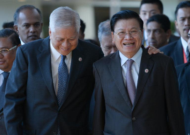 Philippines Foreign Affairs Minister Albert del Rosario (L) jokes with Laos Foreign Minister Thongloun Sisoulith as they arrive for the ASEAN Foreign Ministers Meeting in Kuala Lumpur on April 26, 2015