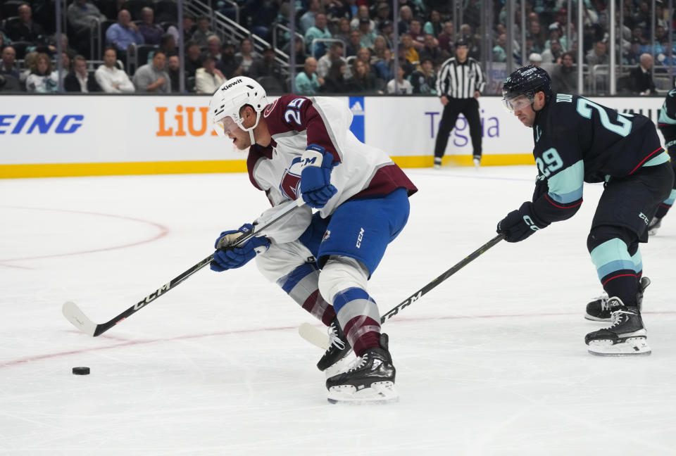 Colorado Avalanche right wing Logan O'Connor (25) looks to shoot and score after making it past Seattle Kraken defenseman Vince Dunn (29) during the second period of an NHL hockey game Tuesday, Oct. 17, 2023, in Seattle. (AP Photo/Lindsey Wasson)