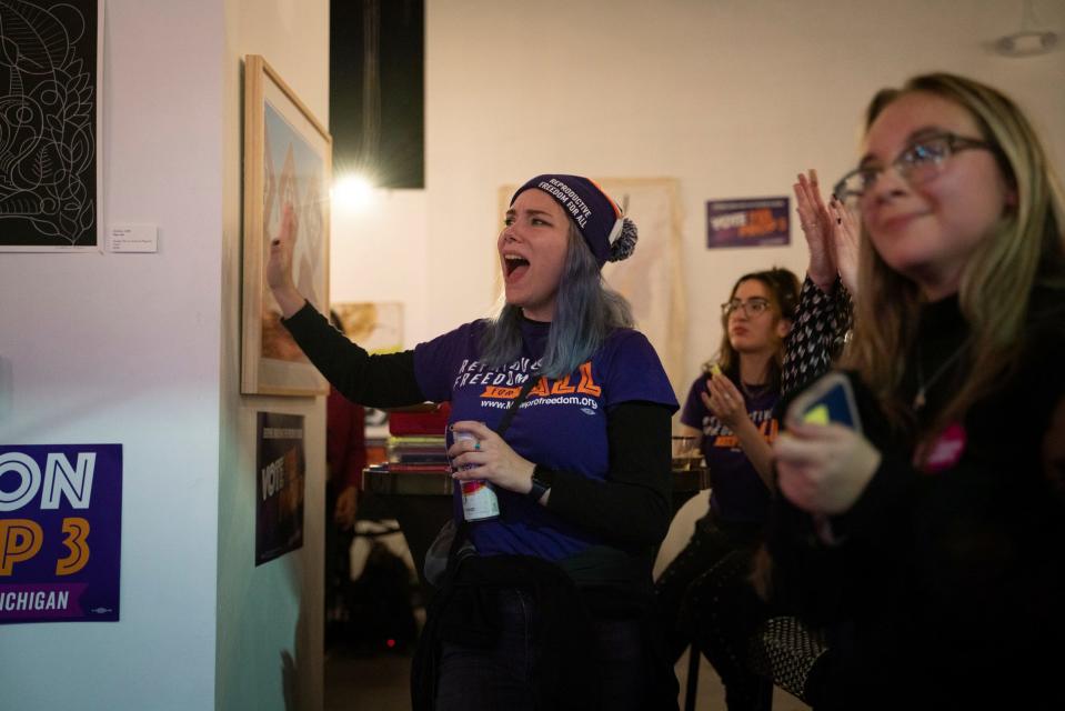 Alex Cascio, 27, of Royal Oak, applauds during a Yes on Proposal 3 campaign watch party at the David Whitney Building in downtown Detroit on Tuesday, Nov. 8, 2022.