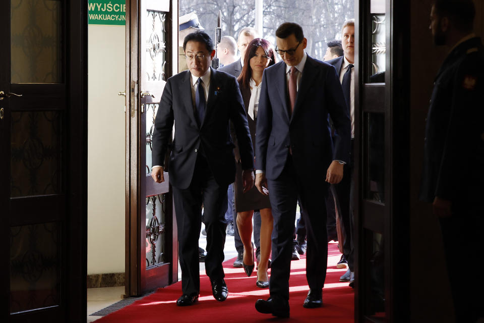 Polish Prime Minister Mateusz Morawiecki, right, arrives with Japanese Prime Minister Fumio Kishida, left, for a meeting in Warsaw, Poland, Wednesday, March 22, 2023. (AP Photo/Michal Dyjuk)