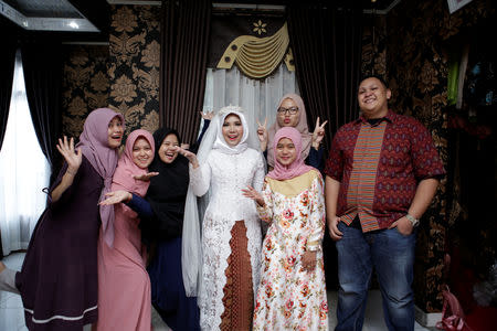 A wedding photo of the bride of a Lion Air flight JT610 victim, who carried on the celebration despite the absence of the groom, in Bangka, Bangka Belitong Province, Indonesia November 11, 2018 in this picture obtained from social media on November 16, 2018. LALA INDRA PERMANA/via REUTERS