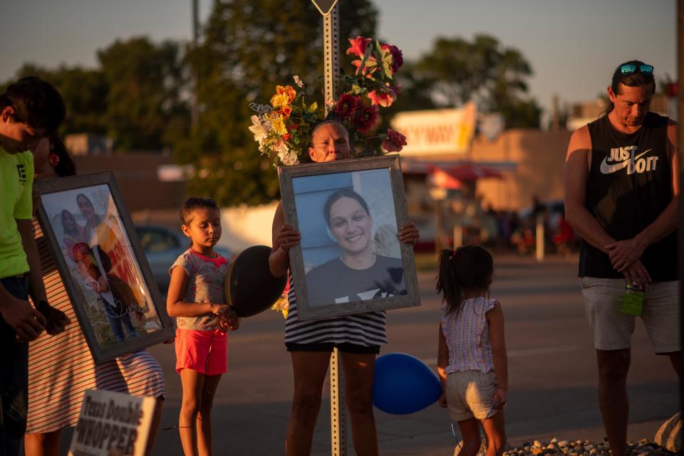 Family members and friends of Jacob James holding photos a day after he was killed in the latest officer-involved shooting in Sioux Falls, on Wednesday, August 10, 2022.