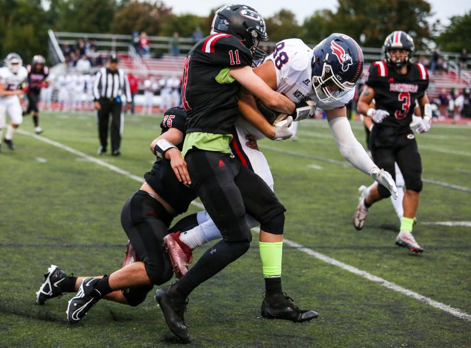 Boonton's #75 Michael Zuercher and #11 Luc Mathis take down North Warren's Craig Shipps during the first half of a football game at Boonton High School on Sept. 30, 2022.