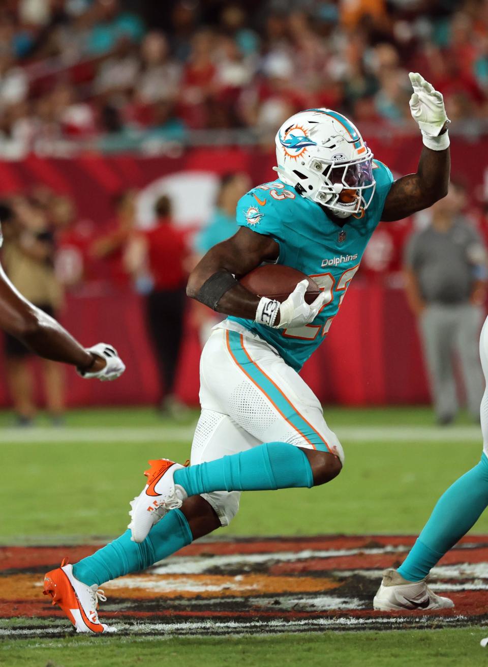 Aug 23, 2024; Tampa, Florida, USA; Miami Dolphins running back Jeff Wilson Jr. (23) runs with the ball against the Tampa Bay Buccaneers during the second quarter at Raymond James Stadium. Mandatory Credit: Kim Klement Neitzel-USA TODAY Sports