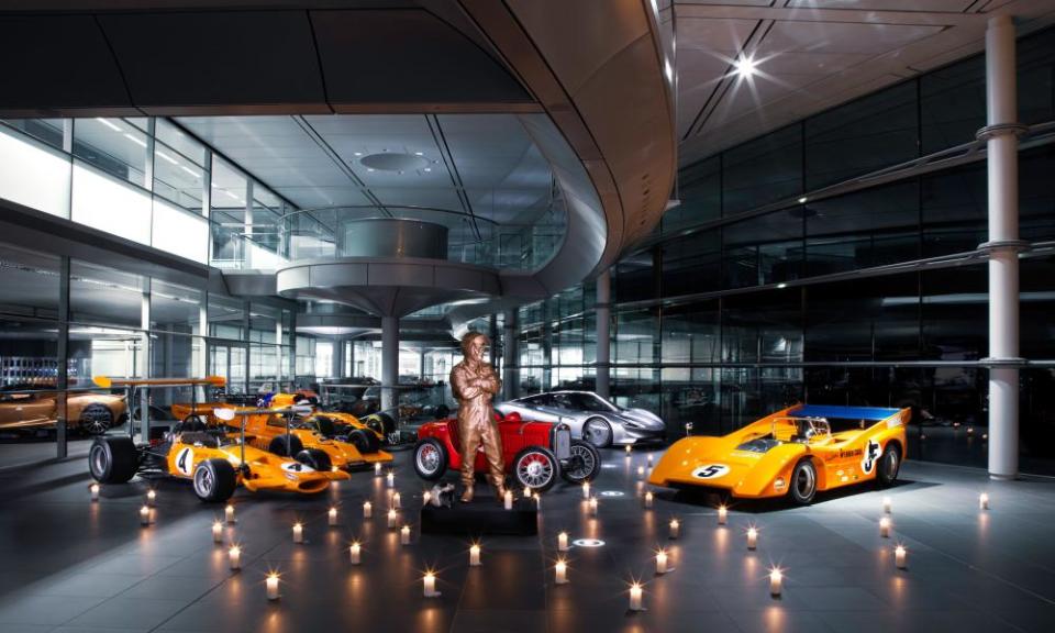 A statute of Bruce McLaren surrounded by racing cars of yesteryear at the Norman Foster-designed facility.