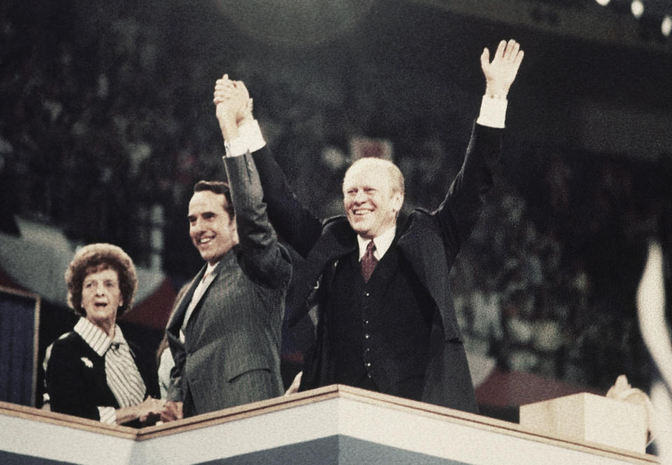 FILE - Sen. Bob Dole, center, his mother Bina Dole, left, and President Gerald Ford appear together on the final night of the Republican National Convention in Kemper Arena in Kansas City, Mo., Aug. 19, 1976. (AP Photo/File)