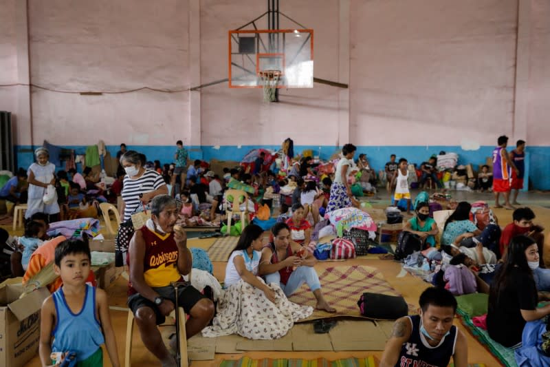 Residents affected by the Taal Volcano eruption rest in an evacuation center in Santo Tomas