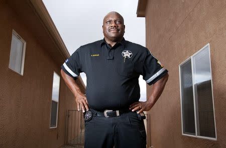 Retired New Mexico state police captain Quintin McShan, who certified at least 140 cases of undocumented immigrant crime victims so that they could get United States U visas and become legal U.S. residents, poses outside his home in Rio Rancho, New Mexico, October 9, 2014. REUTERS/Eric Draper