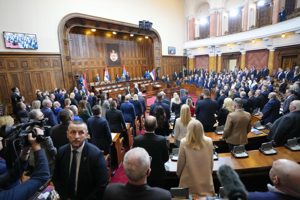 Lawmakers stand for the national anthem before a parliament constitutive session in Belgrade, Serbia, Tuesday, Feb. 6, 2024. Serbia's National Assembly held an inaugural session on Tuesday as ruling nationalists ignored widespread reports that parliamentary and municipal elections held in December were marred by vote rigging and other irregularities.((AP Photo/Darko Vojinovic)