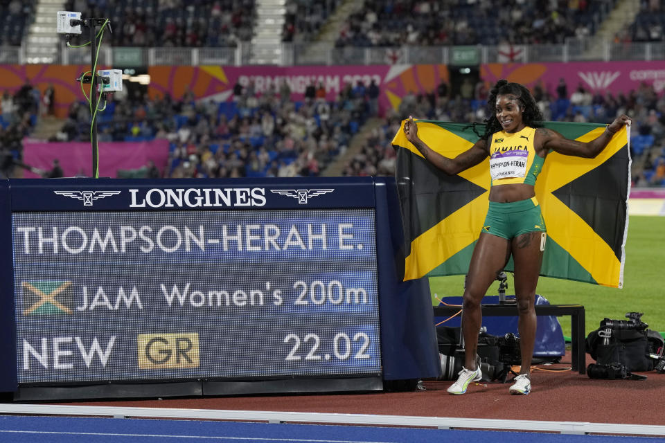 Elaine Thompson-Herah of Jamaica poses after winning the gold medal in the Women's 200 meters setting a new Games record during the athletics competition in the Alexander Stadium at the Commonwealth Games in Birmingham, England, Saturday, Aug. 6, 2022. (AP Photo/Manish Swarup)