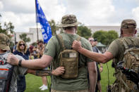 <p>Militia members hold each others backpacks during a pro-Trump “Mother of all Rallies” (MOAR) event on the National Mall in Washington on Saturday, Sept. 16, 2017. MOAR, the “Woodstock of American Rallies,” wants to send a message to Congress, the media and the world that the attendees stand to defend American values and culture. (Photo: Alex Wroblewski/Bloomberg via Getty Images) </p>