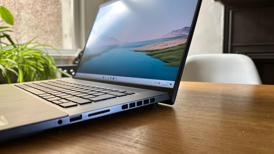 An open Dell Inspiron 16 Plus 7620 sitting on a wooden table