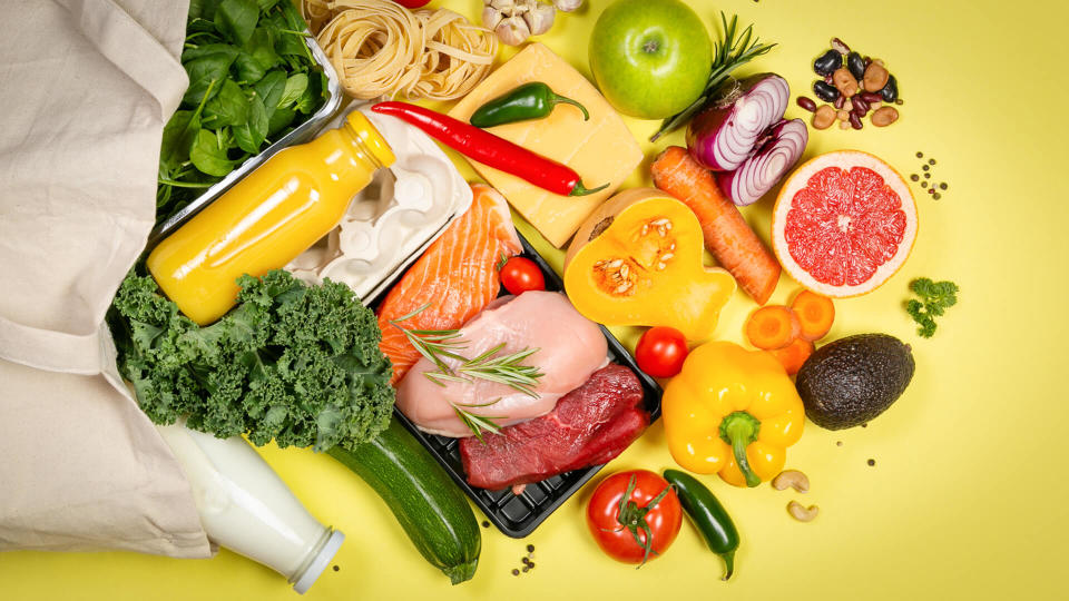 Grocery shopping concept - meat, fish, fruits and vegetables with shopping bag, top view.