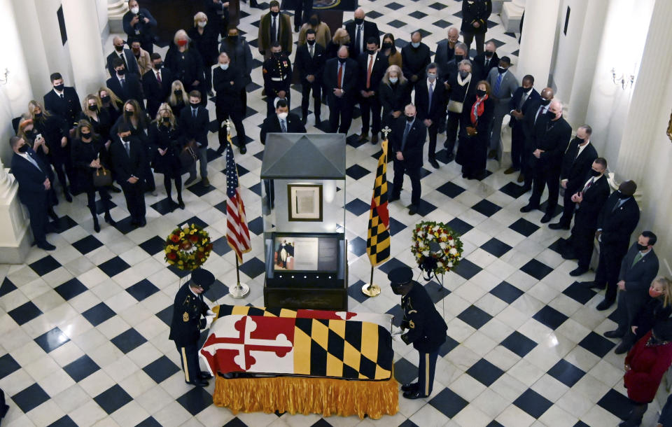 The Maryland National Guard Honor Guard drapes the Maryland flag on the casket of Maryland Senate President Emeritus Thomas V. Mike Miller under the dome of the State House in Annapolis, Md., Thursday, Jan. 21, 2021. (Kim Hairston/The Baltimore Sun via AP, Pool)