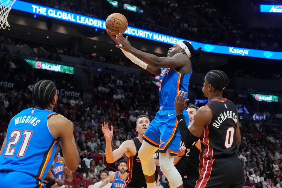 Oklahoma City Thunder guard Luguentz Dort (5) drives to the basket over Miami Heat guard Josh Richardson (0) during the first half of an NBA basketball game, Wednesday, Jan. 10, 2024, in Miami. (AP Photo/Marta Lavandier)