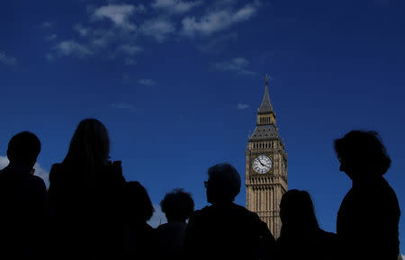 Tourists view the Elizabeth Tower, which houses the Great Clock and the 'Big Ben' bell, at the Houses of Parliament, in central London, Britain, August 16, 2017. REUTERS/Toby Melville