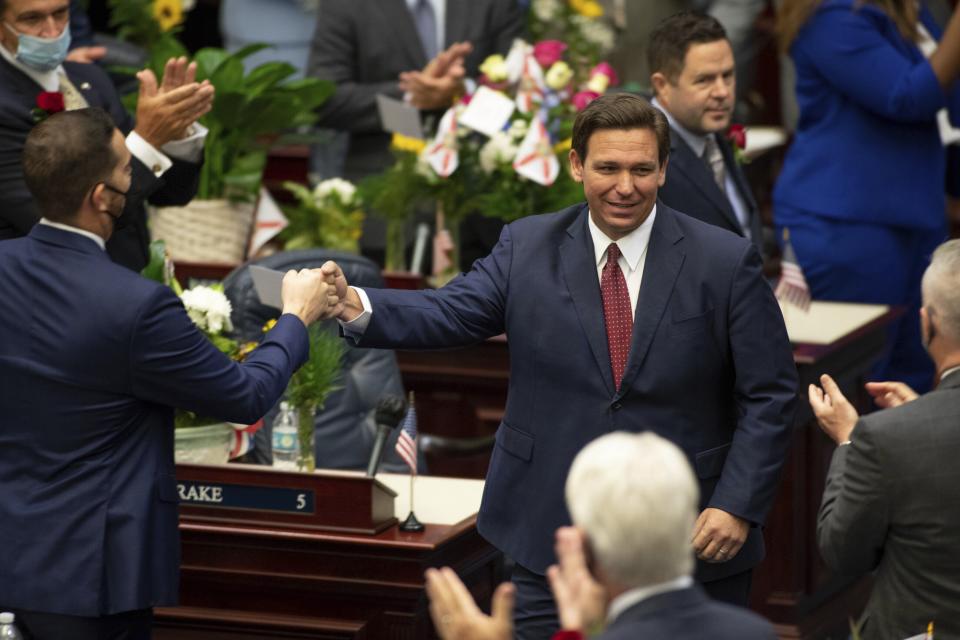 Gov. Ron DeSantis arrives in the House of Representatives chamber to give his State of the State speech on the first day of the 2021 Legislative Session in Tallahassee, Fla. Tuesday, March 2, 2021. (Tori Lynn Schneider/Tallahassee Democrat via AP)