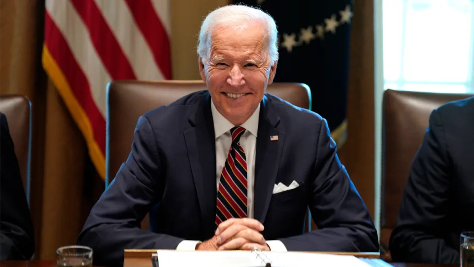 President Biden sits at a desk during a Cabinet meeting.