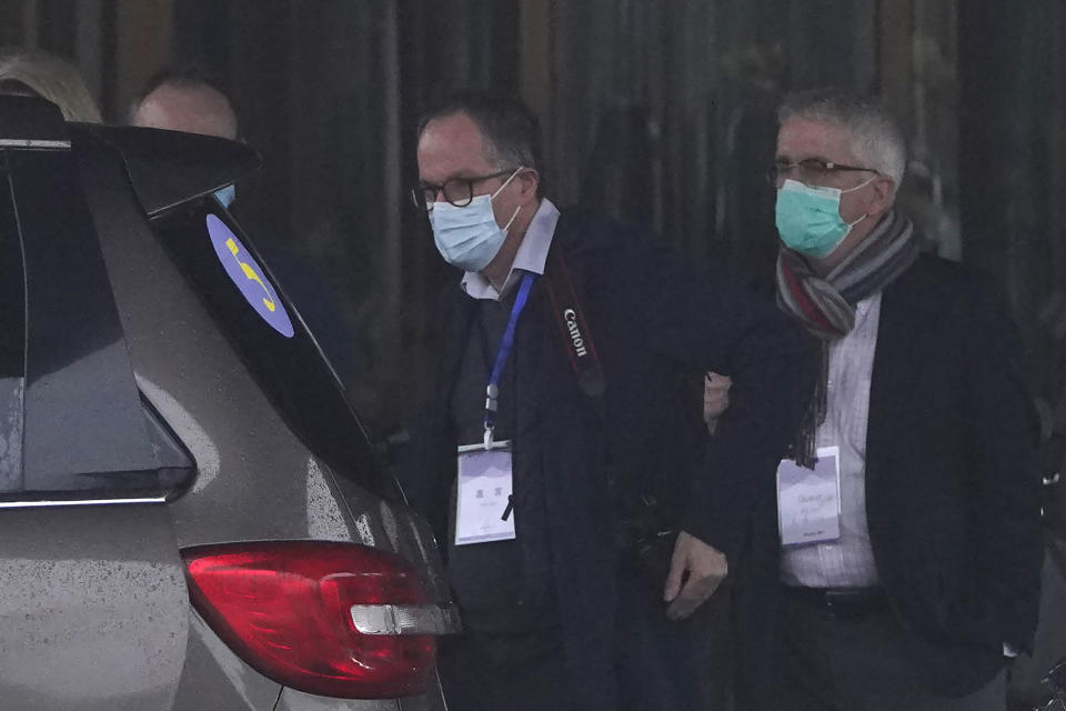 From right, Dominic Dwyer and Peter Ben Embarek of the World Health Organization team prepare to leave for a fourth day of field visits from their hotel in Wuhan in central China's Hubei province on Monday, Feb. 1, 2021. (AP Photo/Ng Han Guan)