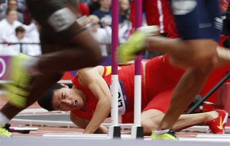 China's Liu Xiang falls after hitting a hurdle in his men's 110m hurdles heat. (Reuters)