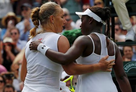 Britain Tennis - Wimbledon - All England Lawn Tennis & Croquet Club, Wimbledon, England - 3/7/16 Russia's Svetlana Kuznetsova embraces USA's Sloane Stephens after winning their match REUTERS/Stefan Wermuth