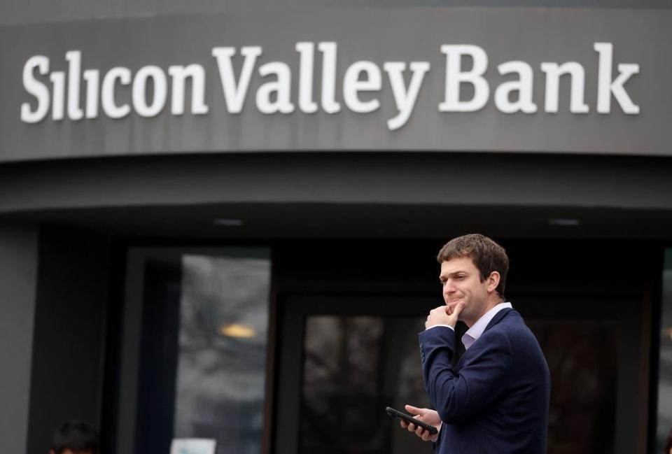 A customer stands outside of the shuttered Silicon Valley Bank headquarters on Friday, March 10, 2023 in Santa Clara, California.