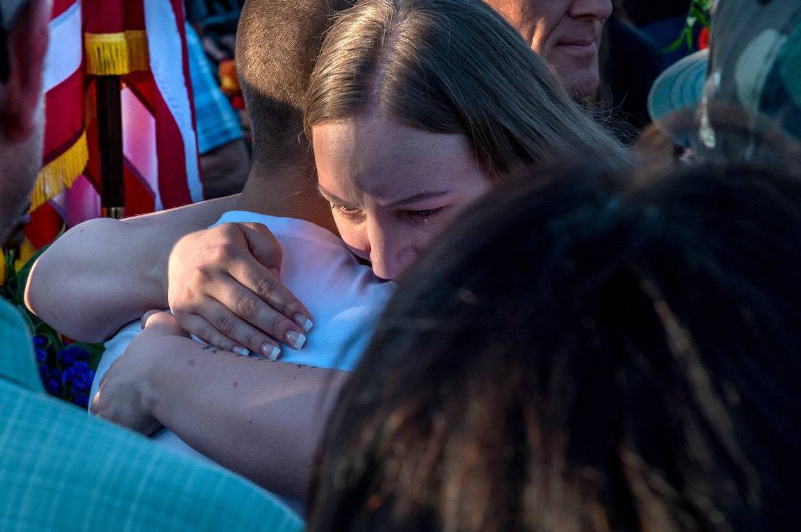 Misty Fuoco, whose sister Marine Sgt. Nicole Gee died in a bombing at Afghanistan’s Kabul airport, gets a hug at a community vigil in Roseville on Tuesday, Aug. 31, 2021. Gee, 23, died with 12 other U.S. service members.