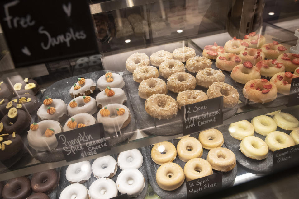 In this Tuesday, Nov. 26, 2019, photo shows donuts are on display at the Oh Mochi! donut shop at the Nordstrom NYC Flagship in New York. Luxury department stores like Neiman Marcus and Saks Fifth Avenue once ruled among the affluent set. Now, they’re fighting a tough battle to lure younger shoppers faced with a lot more shopping choices, including second-hand retailers and fashion rental companies. (AP Photo/Mary Altaffer)