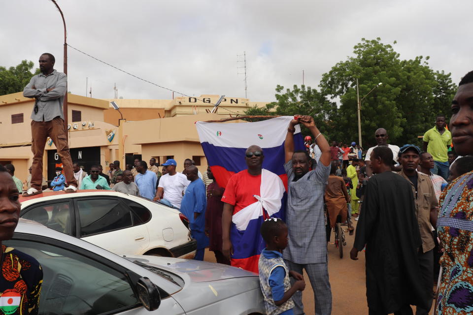 People, some carrying Russian flags, demonstrate in Niger's capital Niamey to show their support for the military rulers who seized power in a July 26 coup, on August 3, 2023. / Credit: Djibo Issifou/picture alliance/Getty