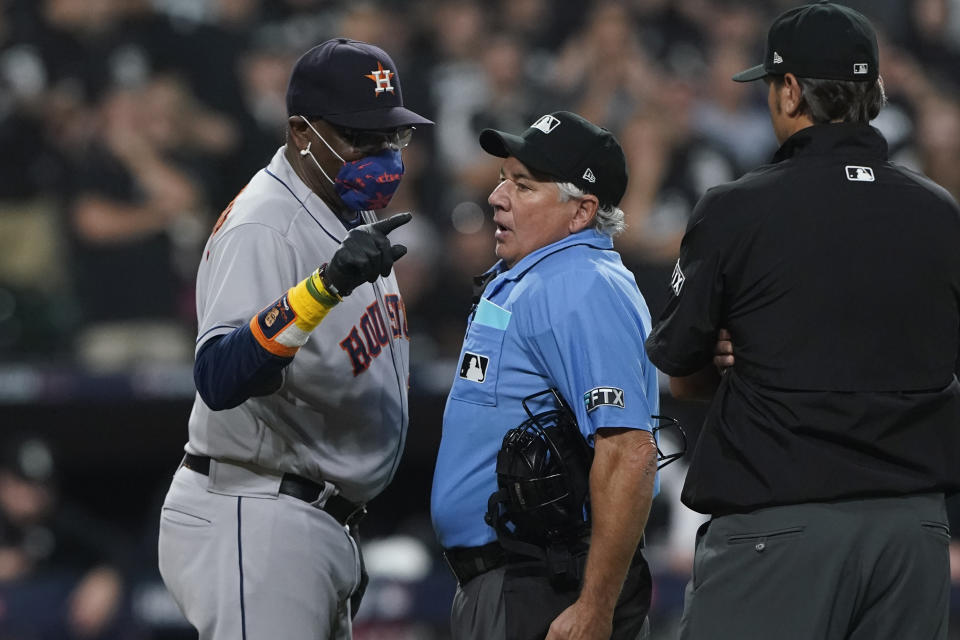 Houston Astros manager Dusty Baker Jr. (12) points to the foul line while arguing with home plate umpire Tom Hallion in the fourth inning during Game 3 of a baseball American League Division Series Sunday, Oct. 10, 2021, in Chicago. (AP Photo/Nam Y. Huh)