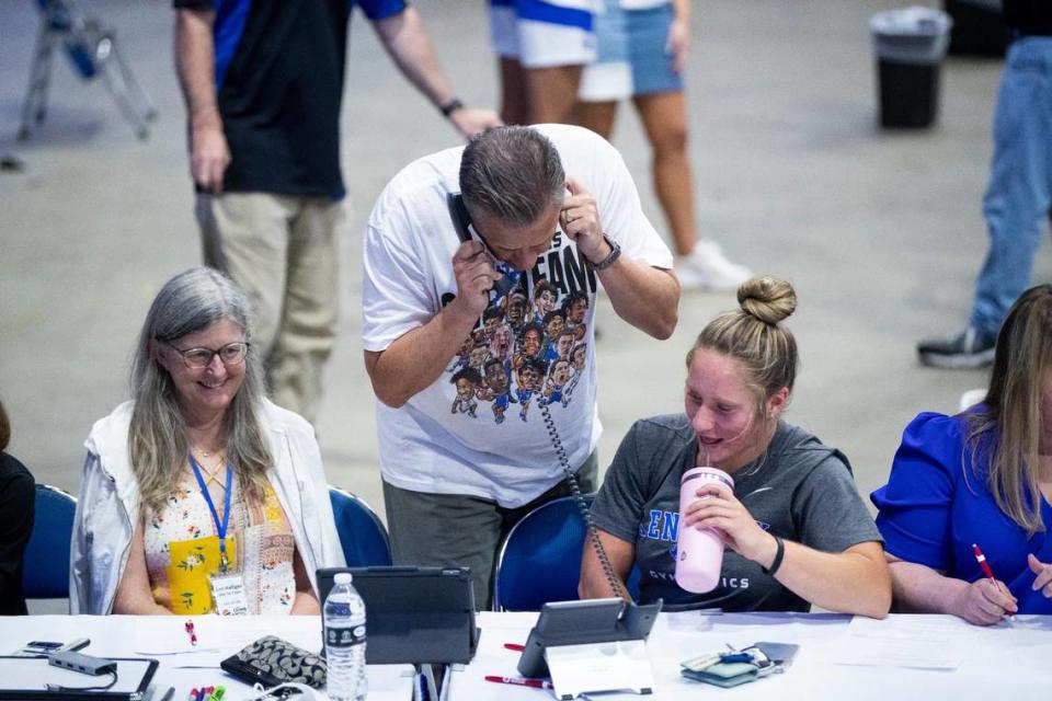 John Calipari works the phones during an open practice and telethon to raise money for flood relief.