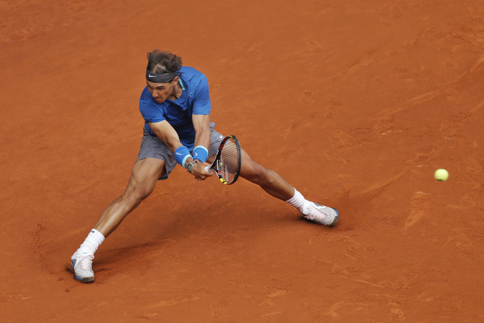 Rafael Nadal from Spain returns a ball during a Madrid Open tennis tournament match against Juan Monaco from Argentina, in Madrid, Spain, Wednesday, May 7, 2014. (AP Photo/Andres Kudacki)